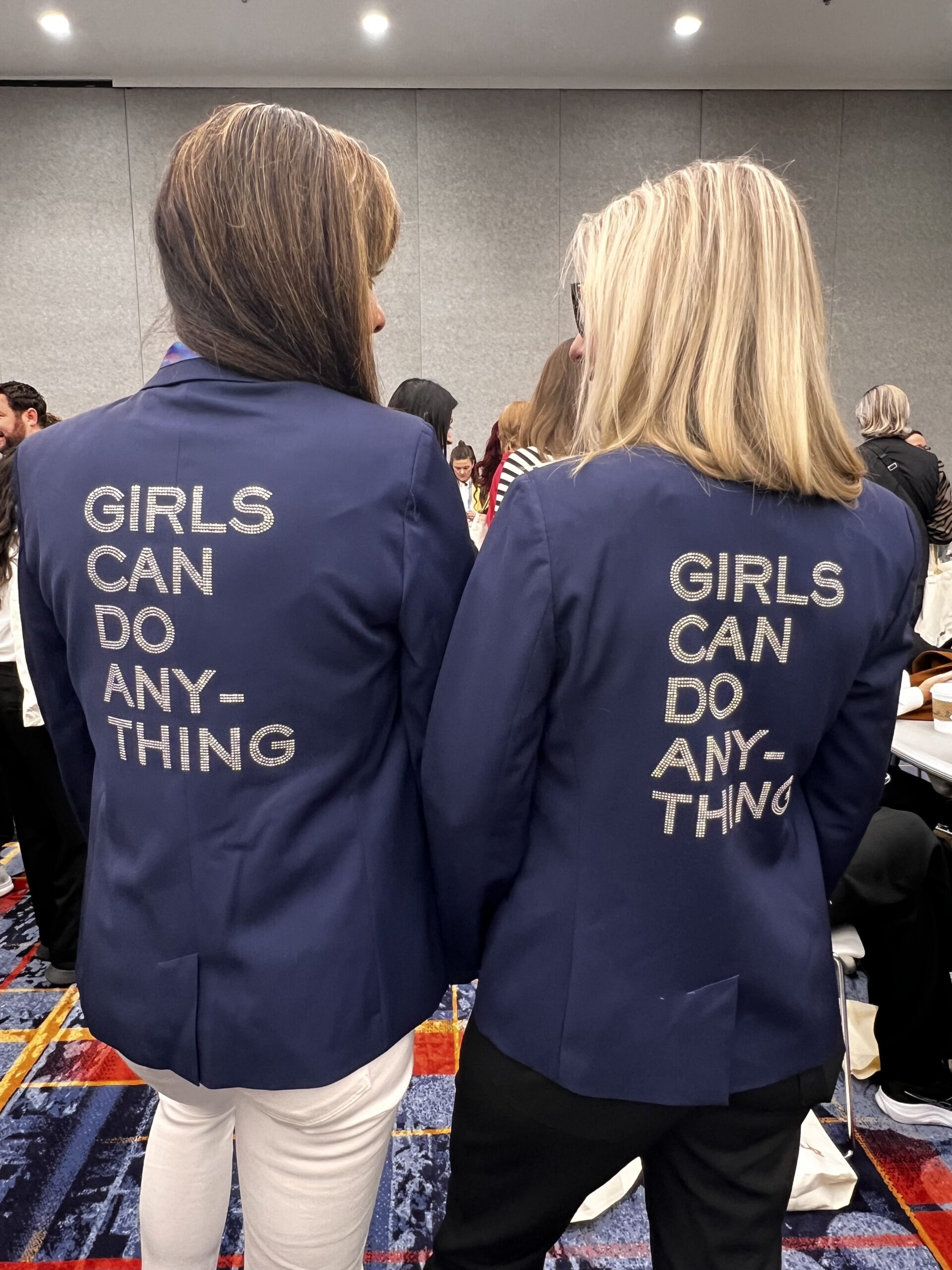 Amsara Health founders wearing Girls Can Do Anything jackets at a women in technology conference