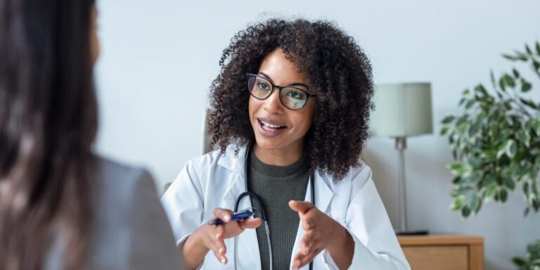 Menopause-certified clinician explaining a treatment plan to a patient during a consultation