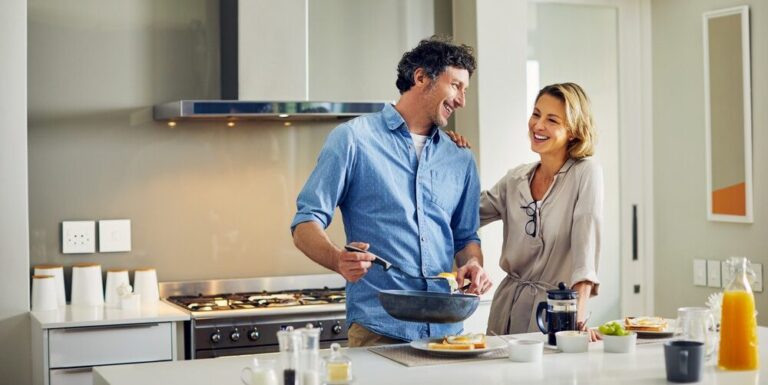 Midlife couple cooking a healthy breakfast together at home